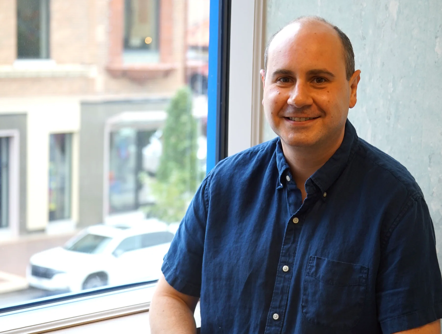 Dr. Eli Wolkoff smiling in his Country Club Plaza office